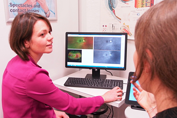 A patient at Paul Verity Opticians in Ilkley using an Optomap Daytona retinal screening machine